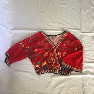 Flowery reddish-orange blouse.